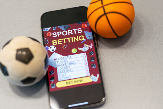 smartphone with application for sport bets and a basketball ball, concept of online bets 