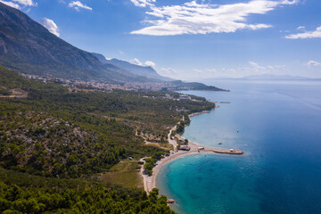 Aerial drone view . Beautiful coastline, white pier going into the sea, blue sea. Makarska is a...