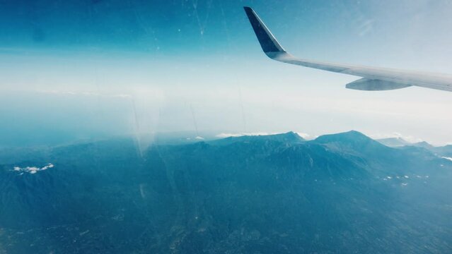 Window view from the airplane flying over Indonesia