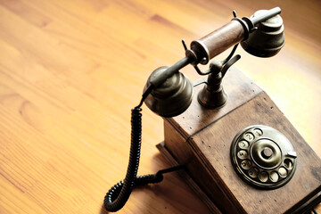 Vintage old wooden phone on a table.
