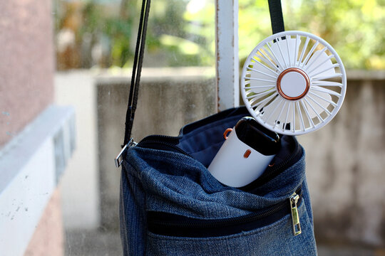 Portable rechargeable electric fan in a bag