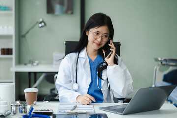 Female medicine doctor, physician or practitioner involved in cellphone call conversation giving professional consultation to patients. Medic tech concept.
