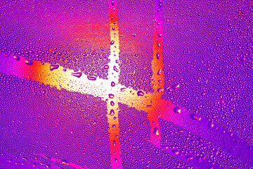 Drops of water on the glass. Abstract background for design. Wet glass with abstract light