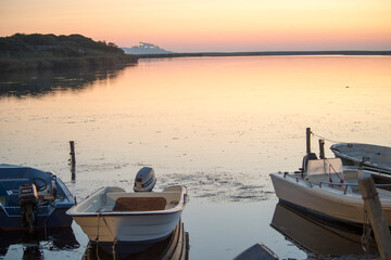 boat at sunset. Valledoria, Sardinia, Italy. Coghinas river-mouth at sunset. Foci del fiume...