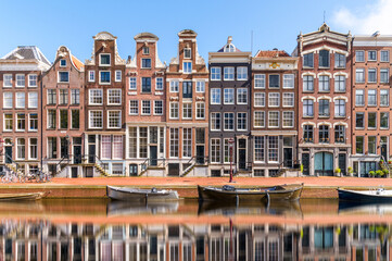 Amsterdam houses next to the canal on a sunny day