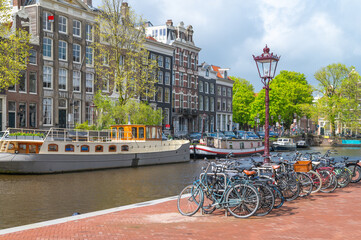 Bicycles next to a canal in Amsterdam, the Netherlands on a sunny day