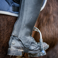 Close up of a dirty riding boot