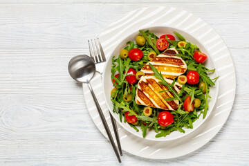 salad with grilled halloumi greek cheese in bowl