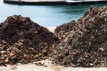 Metal scrap stacked on the port dock, ready to be transferred to the recycling plant.