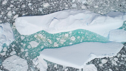 Turquoise Iceberg Brash Ice Aerial Top Down View. Huge Snow Ice Float in Ocean Arctic Coast, Global...