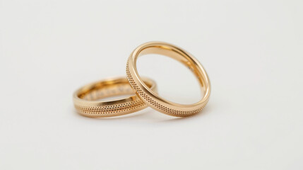 Close-up view of a pair of gold wedding rings isolated on white background