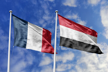 3d illustration. France and Yemen Flag waving in sky. High detailed waving flag. 3D render. Waving in sky. Flags fluttered in the cloudy sky.