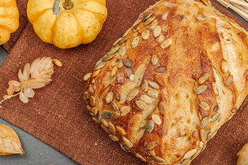 Fresh bread with pumpkin seeds. Home baking concept. Autumn decor