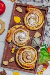 Apple roses pie with sugar powder. Traditional autumn baking, fall decor, flat lay