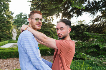 LGBT couple sharing a warm embrace amid nature's tranquility.