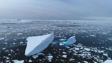 Antarctica melting blue water iceberg aerial view. Antarctic ocean environment. Ice nature...