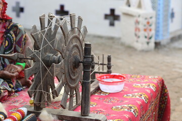 Traditionally makes yarn with a spindle wheel , A demonstration of a traditional cloth weaving...