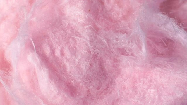 Light pink sweet fluffy cotton candy texture circle rotation close up top view