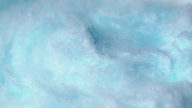 Light blue sweet fluffy cotton candy texture circle rotation close up