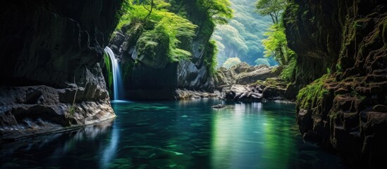 A serene waterfall cascading in a cavern amid lush greenery