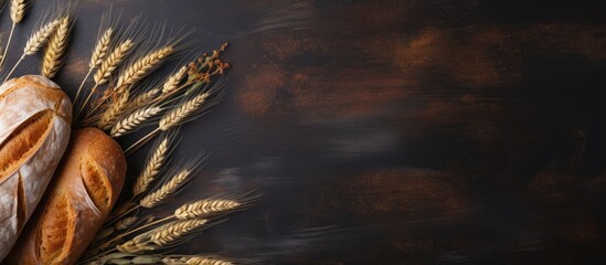 Various loaves of bread and wheat close-up on wooden surface