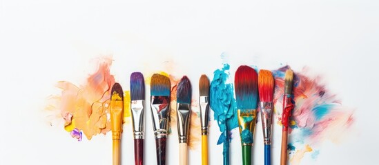 Paint brushes neatly arranged on white background