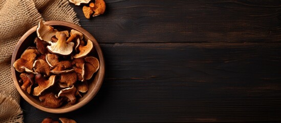 Wooden bowl filled with dried mushrooms on table - Powered by Adobe