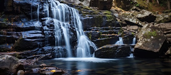 Waterfall in forest with cascading water over stones