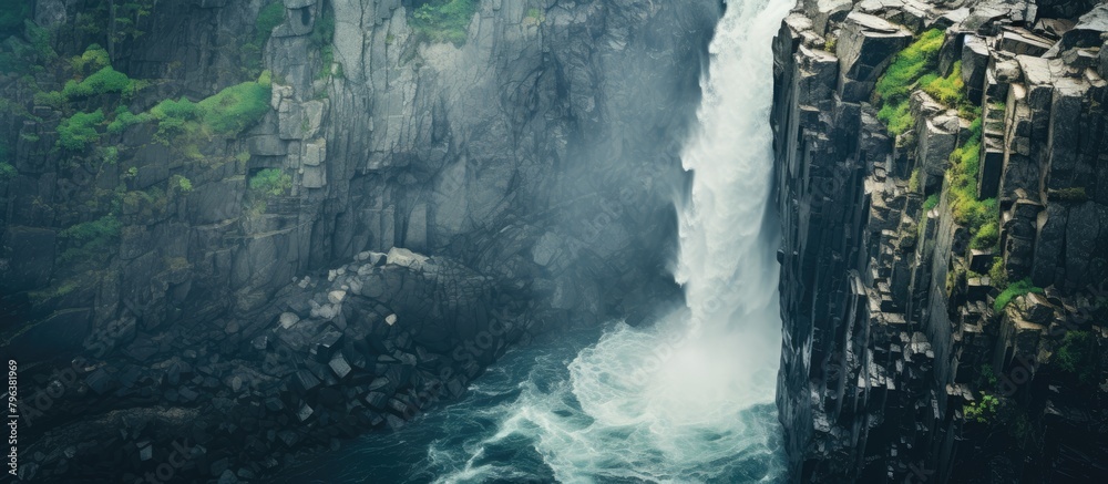 Poster waterfall cascading down rocky cliffs during the day
