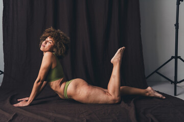 Full size photo of young lady seduce lying posing floor dressed khaki lingerie studio background no...
