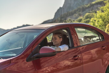 Woman driving a car. A lady in sunglasses takes the wheel of her