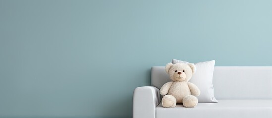 Teddy bear on white couch