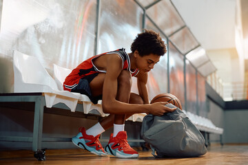 Young black basketball player preparing for sports training.
