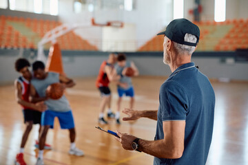 Rear view of basketball coach during sports training.