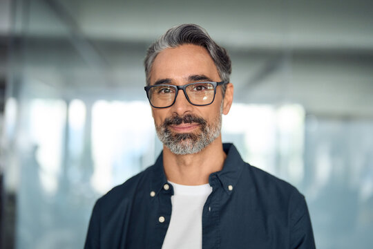 Fototapeta Happy middle aged professional business man, smiling mature executive ceo manager, 45 years old male entrepreneur, confident business owner wearing glasses in office. Headshot portrait.