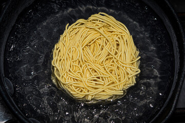 Nest noodles in the boiling water