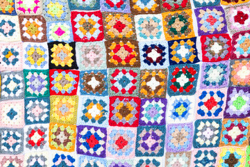 Fototapeta premium Multi colored blanket in wool, square geometric background, retro decorative pattern