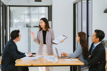 Business people meeting coworkers working together in boardroom, brainstorming, discussing and analyzing and planning business strategy