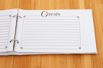 Retro old white and black guest book on a desk