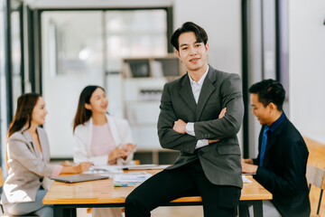 Young multiethnic diverse creative asian group huddle and high five hands together in office workshop with success or empower expression in teamwork. Young asian marketing team with copy space