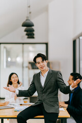 Young multiethnic diverse creative asian group huddle and high five hands together in office workshop with success or empower expression in teamwork. Young asian marketing team with copy space