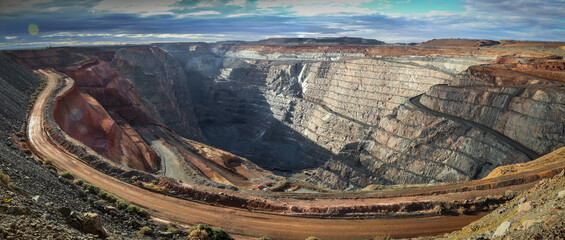 A panorama image of the Kalgoorlie gold mine Super Pit in the dusty late afternoon light.