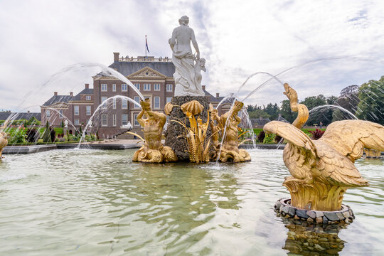 Beautiful gilded ornaments spray water upwards in a fountain in front of Paleis Het Loo in Apeldoorn, Netherlands