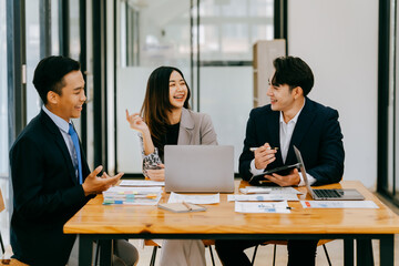 Meeting of Asian business people who are committed to work. Creative business teams work together in the office, discussing issues that need to be resolved, and