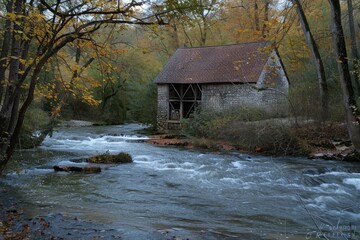 A small wooden building located next to a peaceful river. Suitable for various outdoor themes