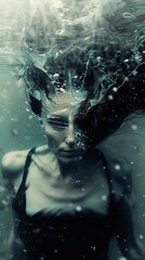 Captivating underwater image presenting a figure's silhouette with flowing hair, evoking a mystical ambiance