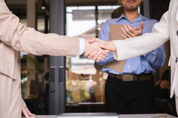 Successful negotiation, handshake, two businessmen shaking hands with partners to celebrate...