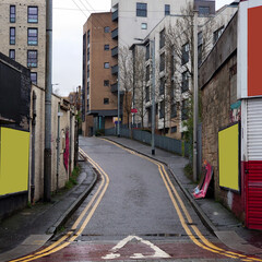 A city side street with covered billboards