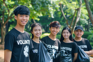 Group of volunteers collecting garbage in the park. Concept of volunteering and environmental protection