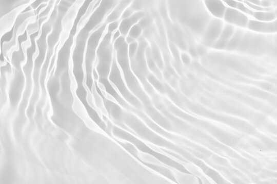 Abstract white water ripple surface with sunlight effects. Blurred transparent and shining summer texture background